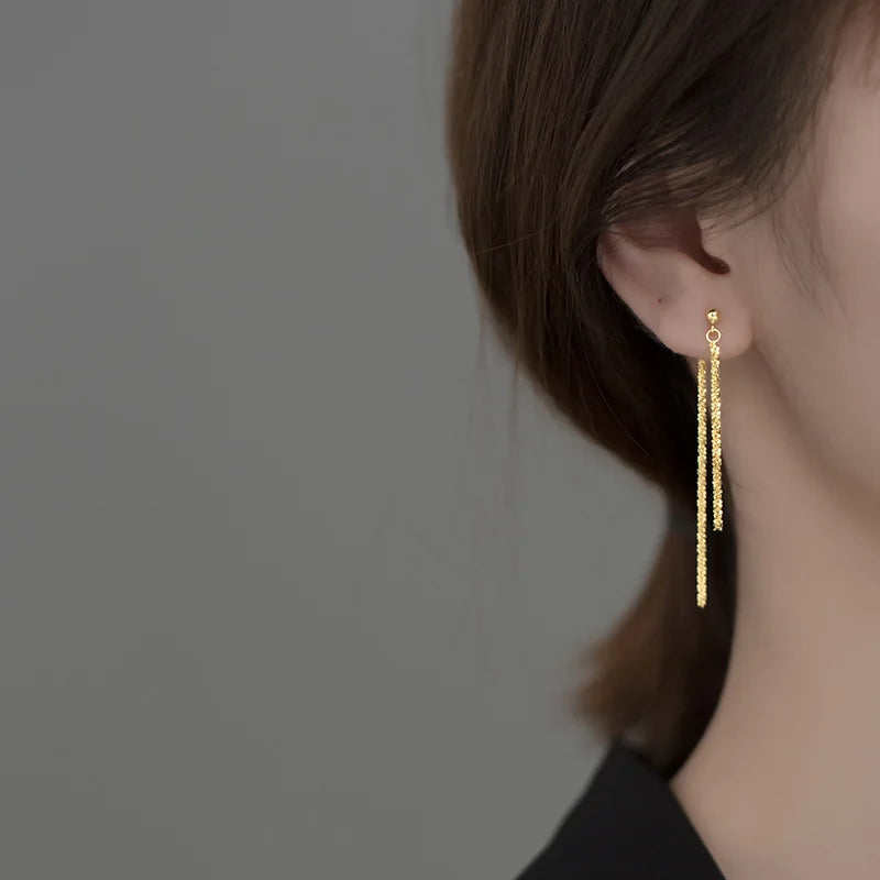 Showing geometric tassel design and gold finish