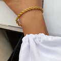Geometric stainless steel bracelet in gold on wrist