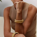 18k gold plated geometric opening bangle on wrist