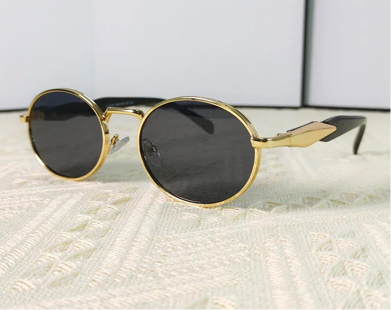 Mirage oval sunglasses in gold and black gradient lenses"