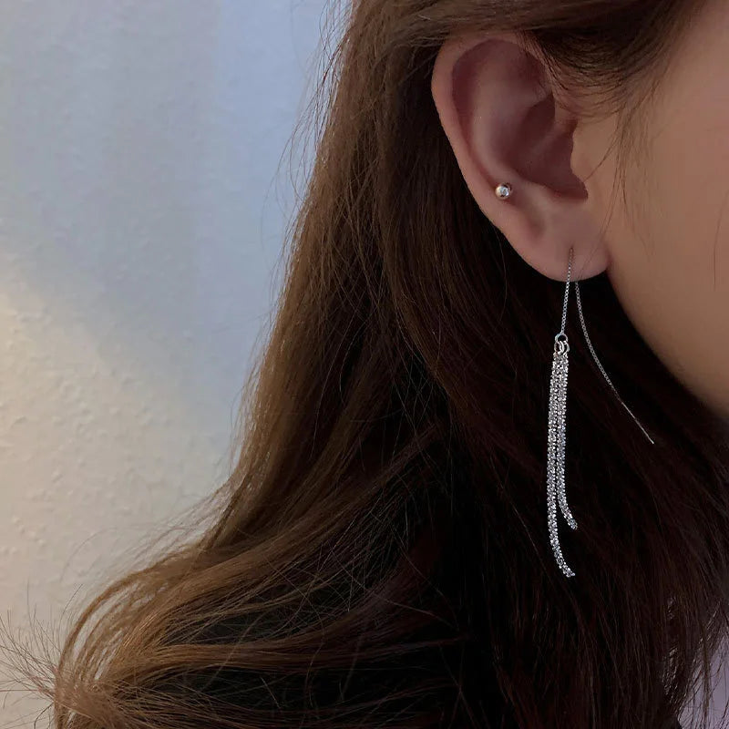 Geometric tassel earring styled on model